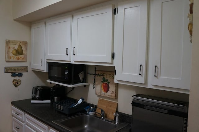 1115 Cherry Hill Dr, Poughkeepsie, NY 12603 - kitchen with black microwave, a sink, dishwasher, white cabinets, and dark countertops
