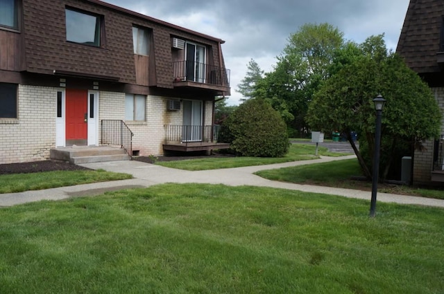 1115 Cherry Hill Dr, Poughkeepsie, NY 12603 - view of front of property featuring brick siding, mansard roof, a front lawn, a balcony, and roof with shingles