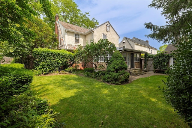 265 Brower Ave, Rockville Centre, NY 11570 - view of side of property with a chimney