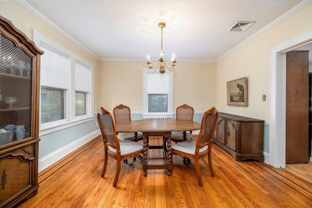 265 Brower Ave, Rockville Centre, NY 11570 - dining space with a chandelier, crown molding, and light wood-type flooring