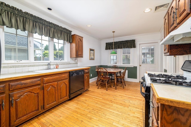 265 Brower Ave, Rockville Centre, NY 11570 - kitchen featuring black dishwasher, range with gas cooktop, light countertops, under cabinet range hood, and ornamental molding