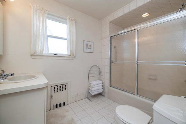 265 Brower Ave, Rockville Centre, NY 11570 - bathroom featuring radiator heating unit, vanity, shower / bath combination with glass door, and tile patterned flooring