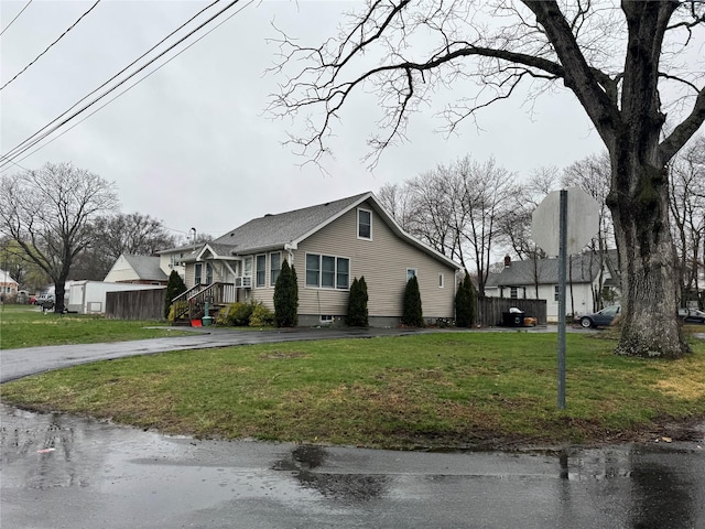 3 Ocean Ave, Mastic, NY 11950 - view of front facade with asphalt driveway and a front yard