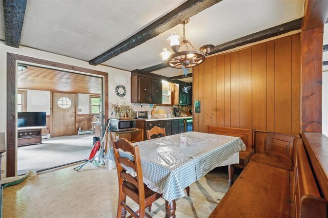dining area with a chandelier, wooden walls, beam ceiling, and a baseboard radiator
