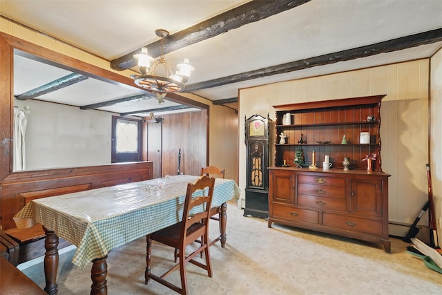 dining space with wooden walls, beam ceiling, a chandelier, and a baseboard radiator
