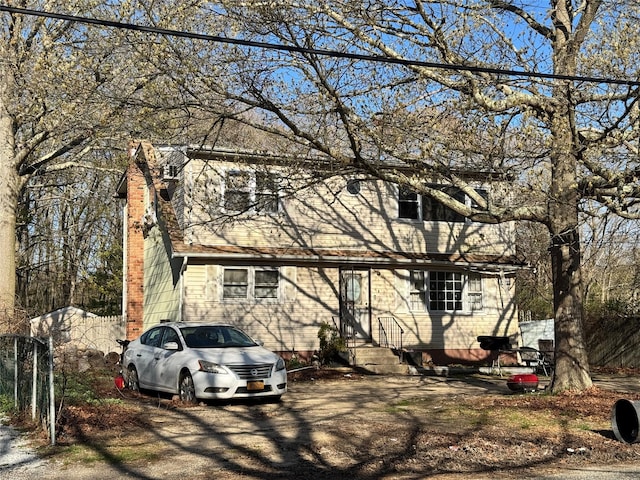 6 Bullard St, Mastic, NY 11950 - view of front of home featuring entry steps and a chimney
