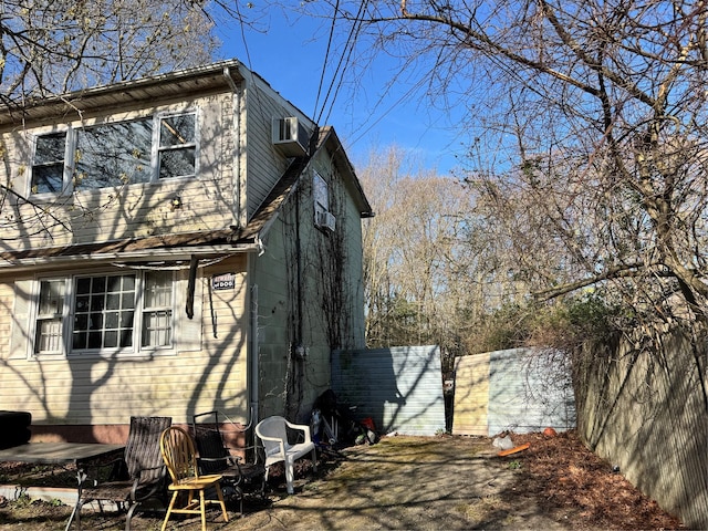 6 Bullard St, Mastic, NY 11950 - view of side of property featuring fence and a wall mounted AC