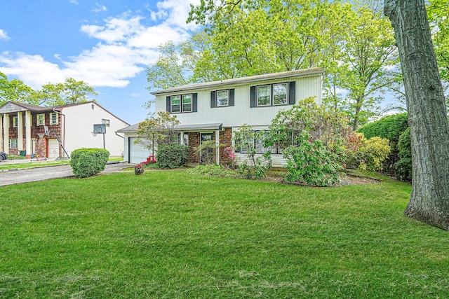 39 Pinewood Dr, Commack, NY 11725 - view of front of property with a front yard, driveway, and a garage