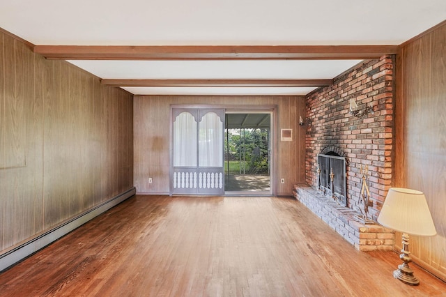 39 Pinewood Dr, Commack, NY 11725 - unfurnished living room featuring wood finished floors, beam ceiling, a baseboard heating unit, a fireplace, and wood walls