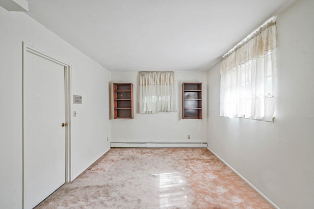 39 Pinewood Dr, Commack, NY 11725 - empty room with a baseboard heating unit, carpet, and baseboards