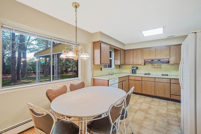 39 Pinewood Dr, Commack, NY 11725 - kitchen featuring white appliances, a baseboard radiator, under cabinet range hood, light countertops, and a sink