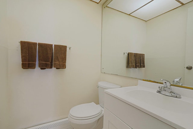 39 Pinewood Dr, Commack, NY 11725 - half bathroom featuring toilet, vanity, and a baseboard heating unit