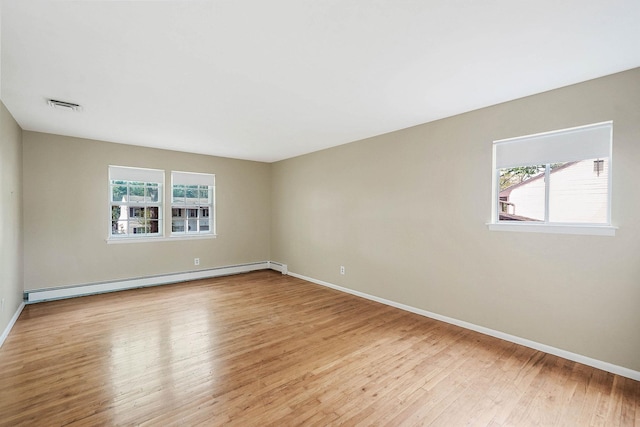 39 Pinewood Dr, Commack, NY 11725 - empty room featuring a baseboard radiator, light wood-style floors, and baseboards
