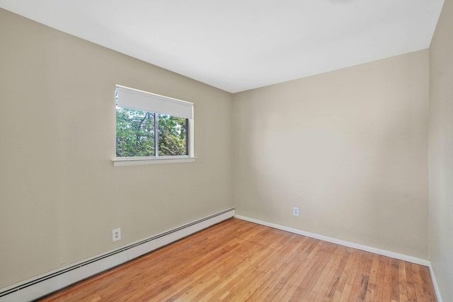39 Pinewood Dr, Commack, NY 11725 - spare room featuring baseboard heating, baseboards, and light wood-type flooring