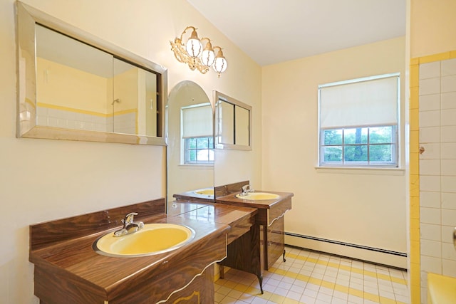 39 Pinewood Dr, Commack, NY 11725 - bathroom featuring a baseboard heating unit, plenty of natural light, two vanities, and a shower