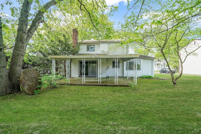39 Pinewood Dr, Commack, NY 11725 - back of house with a chimney, a yard, and a porch