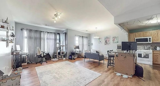162 Commodore Cir E, Arverne, NY 11692 - kitchen featuring white range with electric cooktop, stainless steel microwave, an office area, light wood-style floors, and a kitchen island