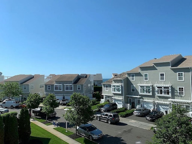 162 Commodore Cir E, Arverne, NY 11692 - view of asphalt road featuring a residential view and sidewalks
