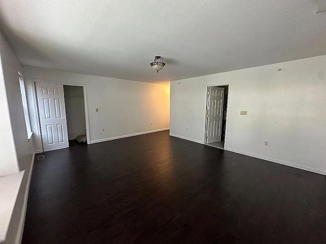 162 Commodore Cir E, Arverne, NY 11692 - spare room featuring dark wood-type flooring and baseboards
