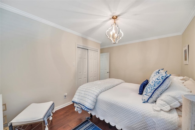 115 19th St, Wading River, NY 11792 - bedroom featuring wood finished floors, crown molding, a closet, baseboards, and a chandelier