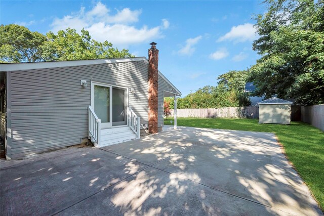 115 19th St, Wading River, NY 11792 - back of property featuring entry steps, a patio, a storage shed, a chimney, and an outbuilding