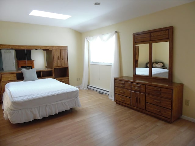 8 Crumley Van Vactor Rd, Ferndale, NY 12734 - bedroom featuring a baseboard radiator, light wood finished floors, baseboards, and vaulted ceiling