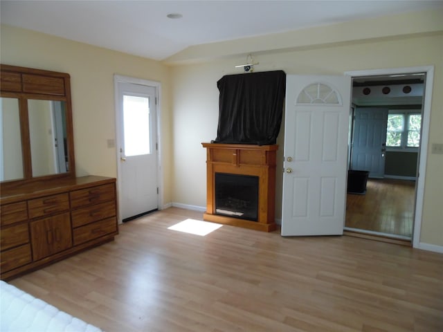 8 Crumley Van Vactor Rd, Ferndale, NY 12734 - unfurnished living room featuring light wood-style floors, a fireplace, lofted ceiling, and baseboards
