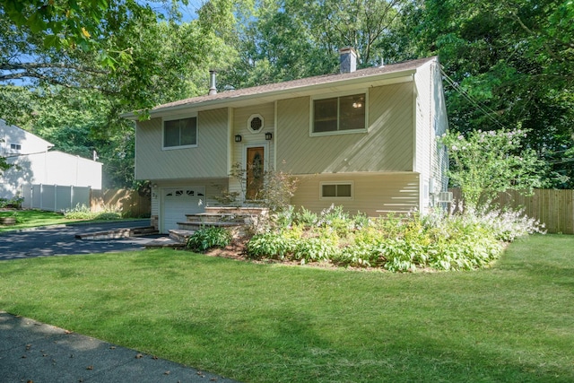 27 Columbus Ave, Kings Park, NY 11754 - bi-level home with a garage, a chimney, and driveway