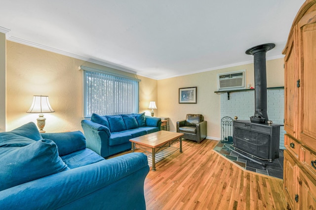 27 Columbus Ave, Kings Park, NY 11754 - living room featuring a wood stove, ornamental molding, light wood-type flooring, and a wall mounted air conditioner
