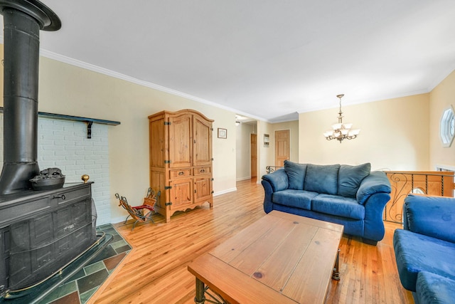 27 Columbus Ave, Kings Park, NY 11754 - living area featuring a wood stove, a chandelier, light wood-style flooring, and ornamental molding