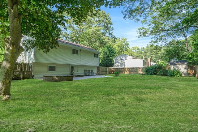 27 Columbus Ave, Kings Park, NY 11754 - fenced backyard with a patio area and a storage shed