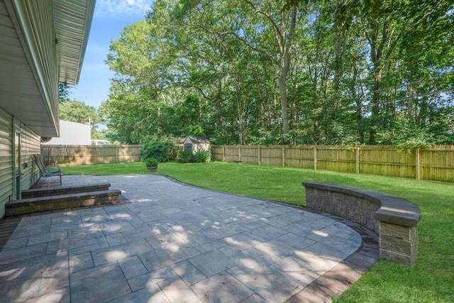 27 Columbus Ave, Kings Park, NY 11754 - fenced backyard with a patio area and a storage unit
