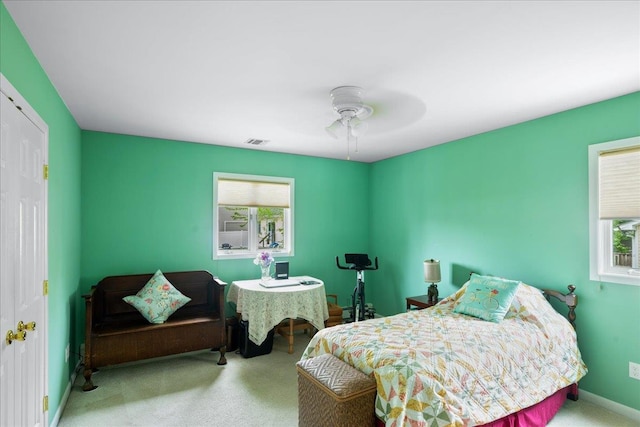 bedroom with multiple windows, carpet flooring, ceiling fan, and baseboards