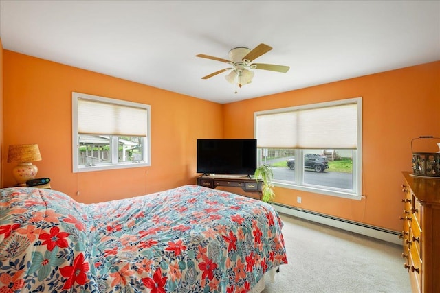 bedroom with baseboard heating, carpet floors, and ceiling fan