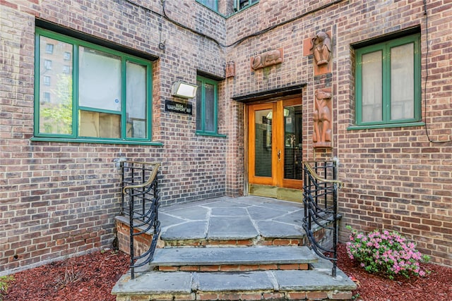 doorway to property with french doors and brick siding