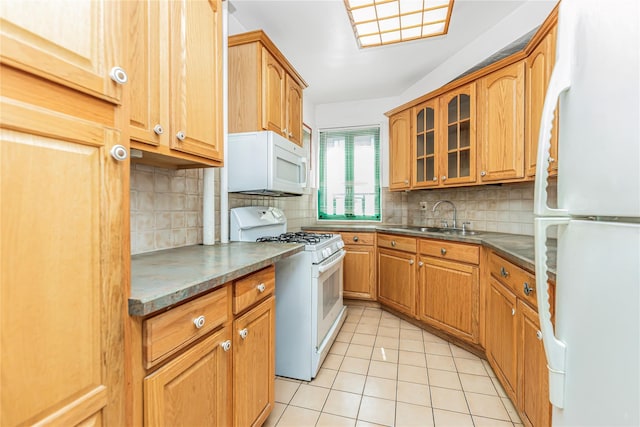 kitchen with white appliances, glass insert cabinets, decorative backsplash, light tile patterned flooring, and a sink