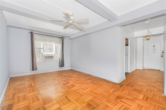 unfurnished room featuring a ceiling fan, baseboards, and cooling unit