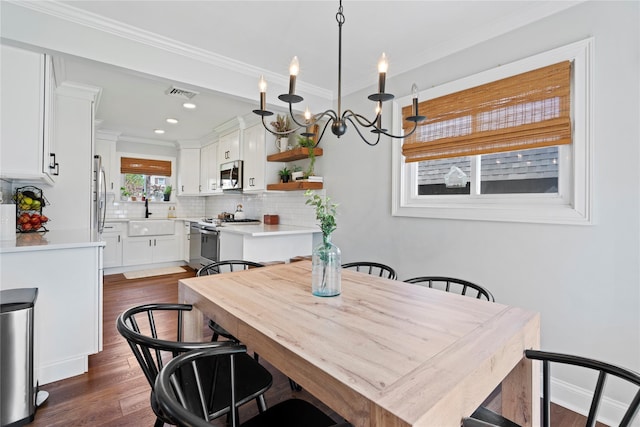 8 Vera Ct, West Islip, NY 11795 - dining area featuring dark wood-style flooring, ornamental molding, a chandelier, and recessed lighting
