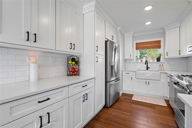 8 Vera Ct, West Islip, NY 11795 - kitchen featuring stainless steel appliances, a sink, crown molding, white cabinetry, and tasteful backsplash