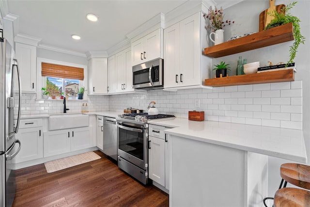 8 Vera Ct, West Islip, NY 11795 - kitchen featuring stainless steel appliances, a sink, white cabinets, crown molding, and open shelves