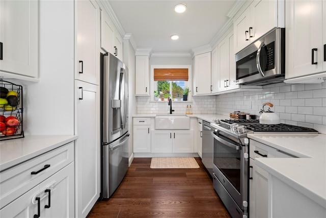 8 Vera Ct, West Islip, NY 11795 - kitchen with stainless steel appliances, a sink, white cabinetry, ornamental molding, and decorative backsplash