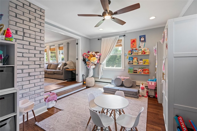 8 Vera Ct, West Islip, NY 11795 - game room featuring ornamental molding, a baseboard heating unit, wood finished floors, ceiling fan, and recessed lighting