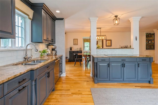 125 Hawkes Ave, Ossining, NY 10562 - kitchen featuring a sink, ornate columns, and light wood-style floors