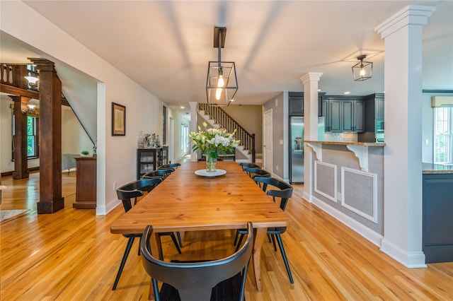 125 Hawkes Ave, Ossining, NY 10562 - dining area with stairway, ornate columns, light wood-style flooring, and baseboards