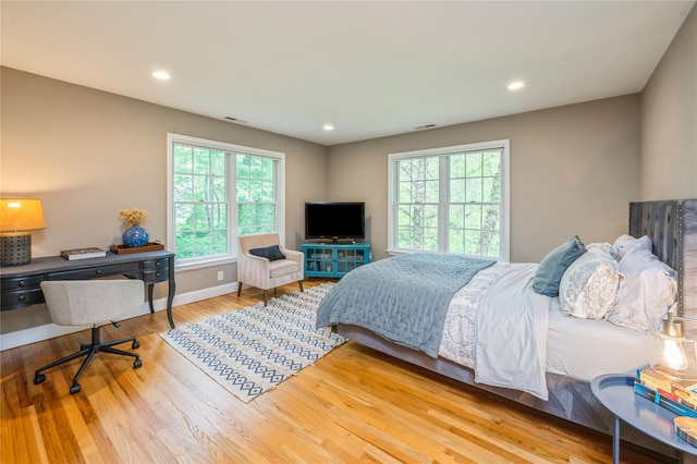 125 Hawkes Ave, Ossining, NY 10562 - bedroom with multiple windows, wood finished floors, recessed lighting, and baseboards