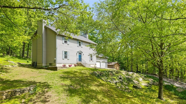 50 Maple Wood Dr, Brewster, NY 10509 - view of front of property featuring a chimney, entry steps, a front yard, and a garage