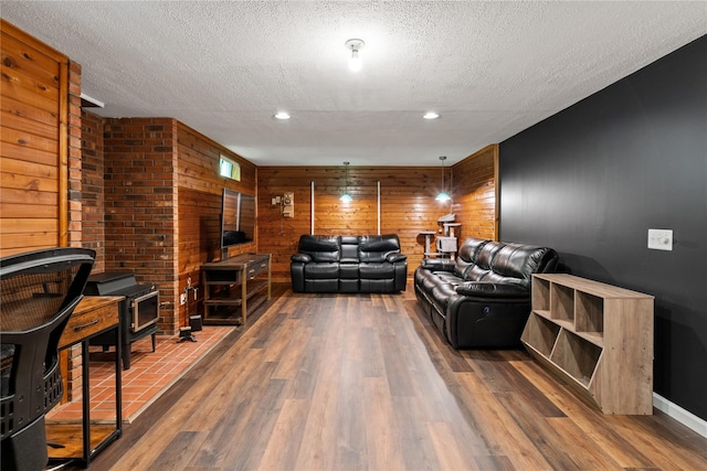 50 Maple Wood Dr, Brewster, NY 10509 - living area with a textured ceiling, wooden walls, wood finished floors, baseboards, and recessed lighting