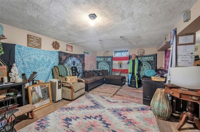living room with a textured ceiling and wood finished floors