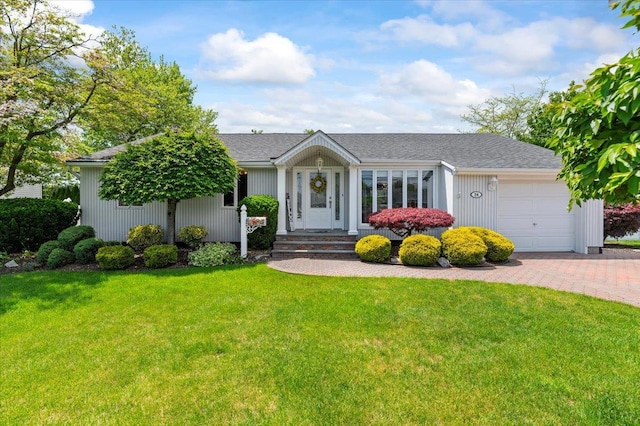 ranch-style house featuring an attached garage, a front yard, and driveway