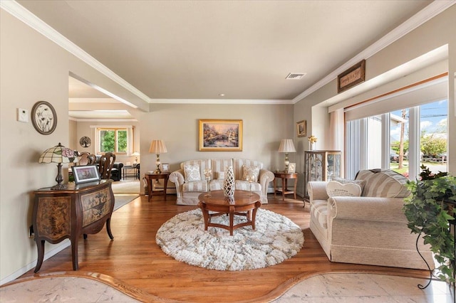 living area with crown molding and wood finished floors